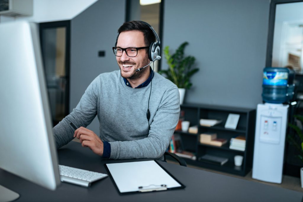 Portrait of a handsome smiling man with headset working